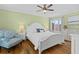 A bright bedroom with a green accent wall, king bed, and lots of natural light at 732 Spinnaker Beachhouse, Seabrook Island, SC 29455