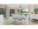 Bright dining area features large windows overlooking the golf course, perfect for enjoying meals with a view at 732 Spinnaker Beachhouse, Seabrook Island, SC 29455