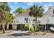 Charming stilted home boasts updated siding and trim and is framed by mature palms and landscaped grounds at 732 Spinnaker Beachhouse, Seabrook Island, SC 29455