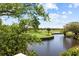 Scenic golf course view with mature trees and a winding water feature, creating a peaceful and picturesque setting at 732 Spinnaker Beachhouse, Seabrook Island, SC 29455