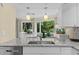 Stylish kitchen featuring granite countertops, sink with faucet, and view to dining area at 732 Spinnaker Beachhouse, Seabrook Island, SC 29455