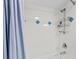 Bright shower with blue accents, white tile, and sleek shower accessories at 732 Spinnaker Beachhouse, Seabrook Island, SC 29455
