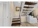 Staircase with carpeted steps and open railing leading to a light-filled landing at 732 Spinnaker Beachhouse, Seabrook Island, SC 29455