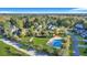 Aerial view of the pool and community park nestled amongst mature trees and single Gathering homes at 853 Bibury Ct, Charleston, SC 29414