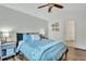 A primary bedroom features a comfortable bed, natural light, and luxury vinyl plank flooring at 853 Bibury Ct, Charleston, SC 29414