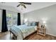 A primary bedroom offers ample natural light, a ceiling fan, and luxury vinyl plank flooring at 853 Bibury Ct, Charleston, SC 29414