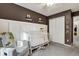 Neutral Bedroom showcasing a white crib, glider, board and batten wall and closet at 853 Bibury Ct, Charleston, SC 29414