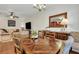 A dining room features a table with chairs, a ceiling fan, and a view into a living room with a sofa at 853 Bibury Ct, Charleston, SC 29414