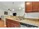 Beautiful kitchen with stone counters and modern appliances that opens to the living room at 853 Bibury Ct, Charleston, SC 29414