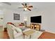 A bright living room features a comfortable sectional sofa, ceiling fan, and a large television at 853 Bibury Ct, Charleston, SC 29414