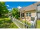 Backyard with white picket fence, lush lawn and mature trees at 8652 Grassy Oak Trl, North Charleston, SC 29420