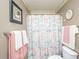 Neutral bathroom with decorative shower curtain and large framed art at 8652 Grassy Oak Trl, North Charleston, SC 29420