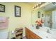 Bathroom features double vanity, ample lighting, decorative accents, and fresh yellow paint at 8652 Grassy Oak Trl, North Charleston, SC 29420