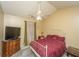 Bedroom with ceiling fan, side table, patterned rug, and red bedspread at 8652 Grassy Oak Trl, North Charleston, SC 29420
