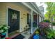 Close-up of a cozy front porch with seating, decorations, and a welcoming entrance at 8652 Grassy Oak Trl, North Charleston, SC 29420