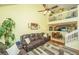 Open-concept living room with high ceilings, fan, dining area, and comfortable brown sofas at 8652 Grassy Oak Trl, North Charleston, SC 29420