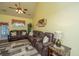 A comfortable living room features a vaulted ceiling, ceiling fan, and a large sectional sofa at 8652 Grassy Oak Trl, North Charleston, SC 29420
