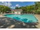 Large community swimming pool surrounded by trees and lounge chairs at 8652 Grassy Oak Trl, North Charleston, SC 29420
