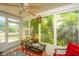 Enclosed porch with ceiling fan and view of the landscaped backyard at 8652 Grassy Oak Trl, North Charleston, SC 29420
