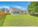 Expansive backyard has a lush lawn and view of the sunroom addition on the house at 9379 Harroway Rd, Summerville, SC 29485