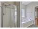 The main bathroom features a separate shower and jetted tub in a brightly lit space at 9379 Harroway Rd, Summerville, SC 29485
