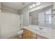 Bright bathroom features a vanity with drawers, a mirror, and a shower-tub combination at 9379 Harroway Rd, Summerville, SC 29485
