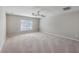 Spacious carpeted bedroom features a ceiling fan, neutral walls and a window that offers natural light at 9379 Harroway Rd, Summerville, SC 29485