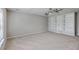 Carpeted bedroom boasts neutral walls, a ceiling fan, window with blinds and built in shelving at 9379 Harroway Rd, Summerville, SC 29485