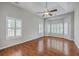 Bright bedroom with hardwood floors, tray ceiling, ceiling fan, and natural light from the windows at 9379 Harroway Rd, Summerville, SC 29485