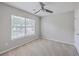 A well-lit bedroom with carpet, a ceiling fan, and a large window at 9379 Harroway Rd, Summerville, SC 29485
