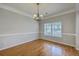 Formal dining room with chair railing, a modern chandelier, and gleaming hardwood floors at 9379 Harroway Rd, Summerville, SC 29485