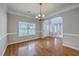 Spacious dining area with hardwood floors, chair railing, and an elegant light fixture at 9379 Harroway Rd, Summerville, SC 29485
