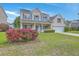 Charming two-story home featuring a well-manicured lawn and a beautiful flower bed at 9379 Harroway Rd, Summerville, SC 29485