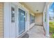 Inviting front porch with classic details and a stylish blue front door at 9379 Harroway Rd, Summerville, SC 29485