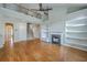 Spacious living room with hardwood floors, fireplace, and an open staircase to the second level at 9379 Harroway Rd, Summerville, SC 29485