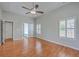A spacious main bedroom featuring hardwood floors, large windows and access to the main bathroom at 9379 Harroway Rd, Summerville, SC 29485