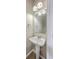 The powder room features a pedestal sink and modern fixtures at 9379 Harroway Rd, Summerville, SC 29485