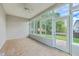 This sunroom features tiled floors, large windows and a door leading to the backyard at 9379 Harroway Rd, Summerville, SC 29485