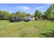 View of the detached garage with parking and storage on a large lawn with mature shade trees at 1019 Levi Lake Rd, Johns Island, SC 29455