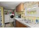 Kitchen and laundry area with stainless steel sink and modern washer and dryer at 1019 Levi Lake Rd, Johns Island, SC 29455