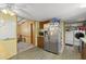 Kitchen view showcasing stainless steel refrigerator and adjacent dining area at 1019 Levi Lake Rd, Johns Island, SC 29455