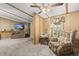 Inviting sitting area with ceiling fan, armchair, and view to living room at 1019 Levi Lake Rd, Johns Island, SC 29455