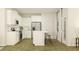 Bright kitchen with white cabinets, stainless steel appliances, an island with seating, and modern finishes at 1022 Sagegrass St, Summerville, SC 29485