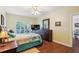 Cozy bedroom featuring a balcony, hardwood floors, and a large dresser at 1025 Riverland Woods Pl # 1008, Charleston, SC 29412