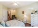 Comfortable bedroom featuring a white metal bed, yellow walls, and a cozy recliner chair at 1025 Riverland Woods Pl # 1008, Charleston, SC 29412
