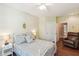 Bright bedroom showcasing a white iron bed frame, light yellow walls, and a cozy chair at 1025 Riverland Woods Pl # 1008, Charleston, SC 29412