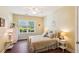 Cozy bedroom with a white iron bed frame, light yellow walls, and bright window at 1025 Riverland Woods Pl # 1008, Charleston, SC 29412