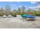 Designated boat storage area with a variety of boats and trailers parked on a gravel lot at 1025 Riverland Woods Pl # 1008, Charleston, SC 29412