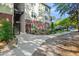 Exterior view of a condo building showing the walkway and colorful landscaping surrounding the property at 1025 Riverland Woods Pl # 1008, Charleston, SC 29412