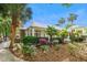 Exterior shot showcasing lush front yard landscaping, palm trees, and clubhouse at 1025 Riverland Woods Pl # 1008, Charleston, SC 29412